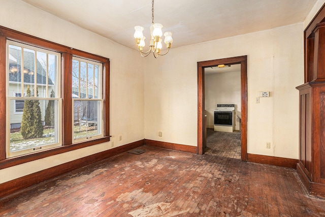 unfurnished dining area featuring dark wood-type flooring, a healthy amount of sunlight, and a notable chandelier