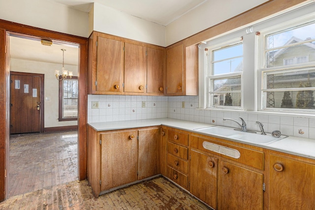 kitchen with tasteful backsplash, sink, plenty of natural light, and dark hardwood / wood-style floors