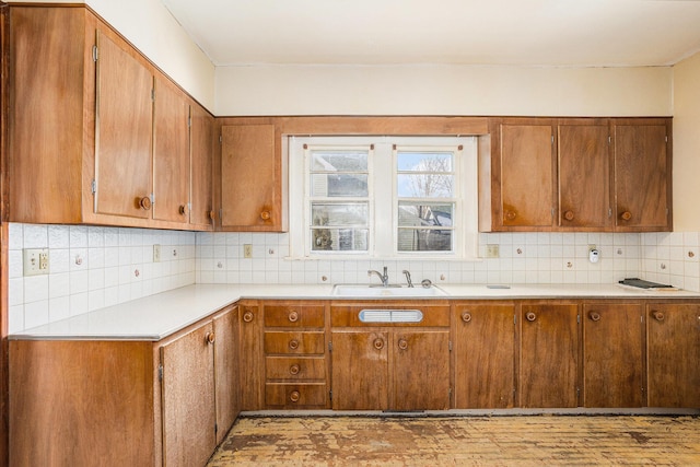 kitchen featuring light hardwood / wood-style floors, sink, and decorative backsplash