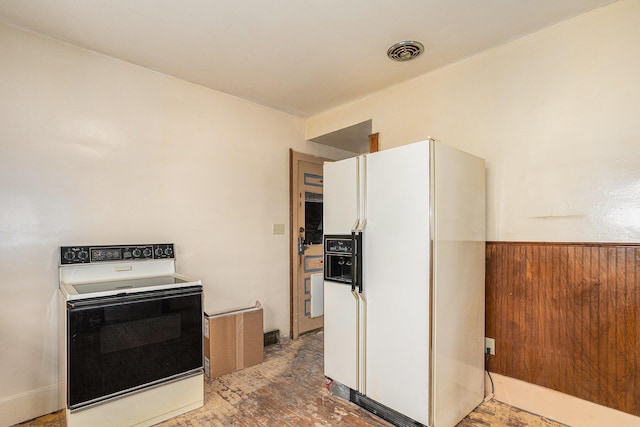 kitchen with range with electric stovetop, white fridge with ice dispenser, and white cabinets