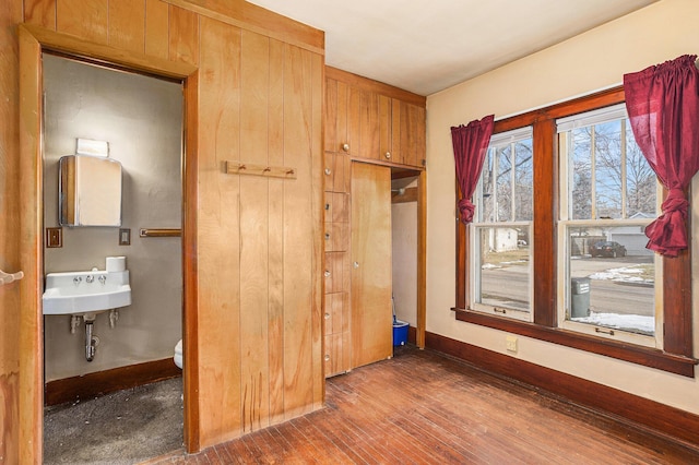 unfurnished bedroom featuring dark hardwood / wood-style floors and sink