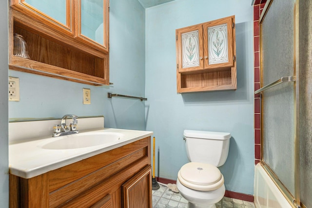 full bathroom featuring vanity, bath / shower combo with glass door, and toilet