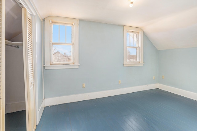 bonus room with lofted ceiling and dark hardwood / wood-style floors