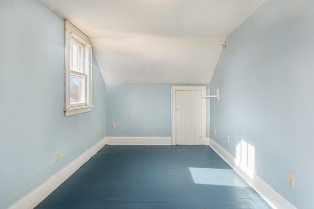 additional living space with lofted ceiling and dark wood-type flooring