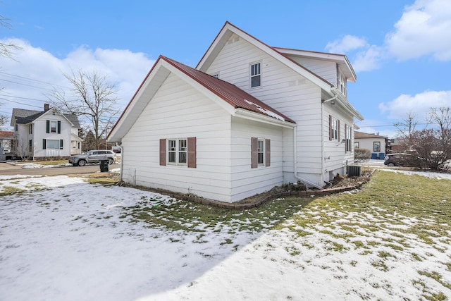 snow covered property featuring cooling unit