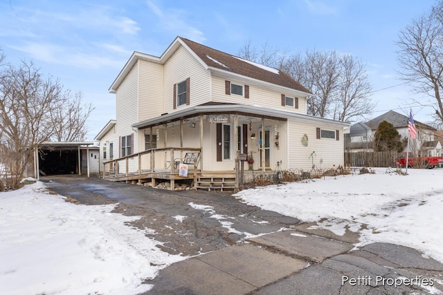 view of front of house featuring a garage and a porch