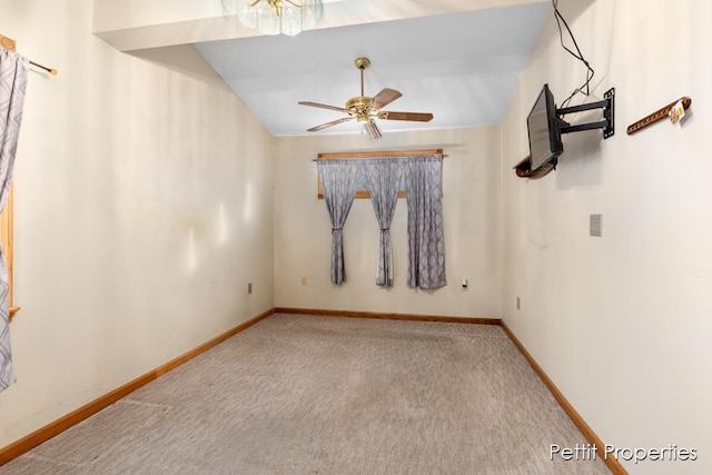 carpeted spare room featuring ceiling fan and lofted ceiling