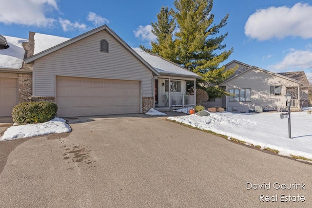 view of front of home featuring a porch and a garage