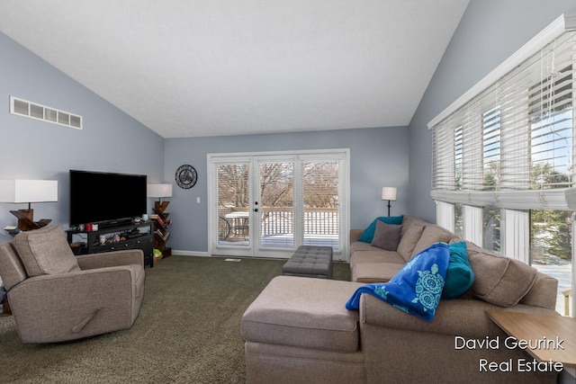 living room with vaulted ceiling and carpet flooring