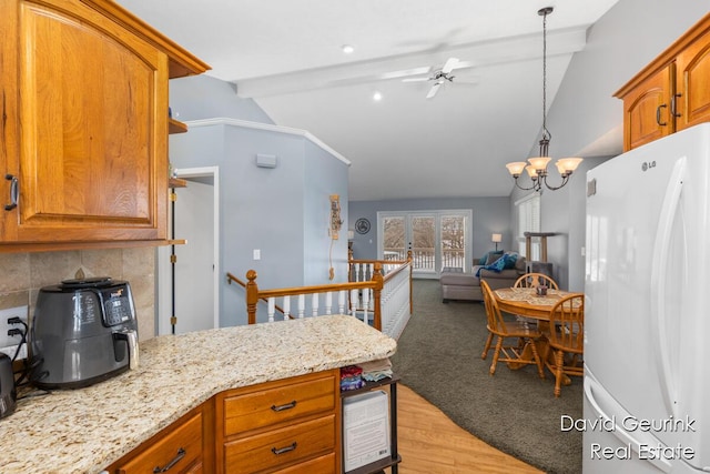 kitchen featuring lofted ceiling with beams, tasteful backsplash, hanging light fixtures, white fridge, and light hardwood / wood-style floors