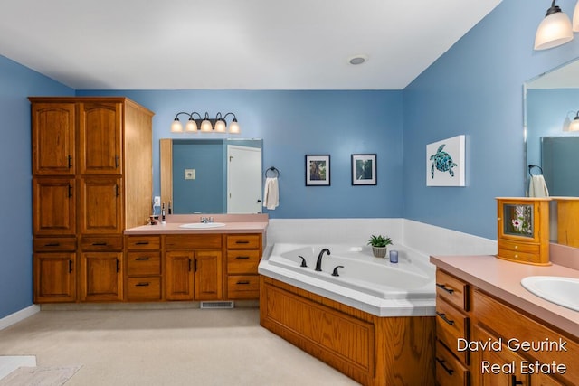 bathroom with a tub to relax in and vanity