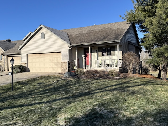 ranch-style house featuring a shingled roof, covered porch, concrete driveway, a front yard, and a garage