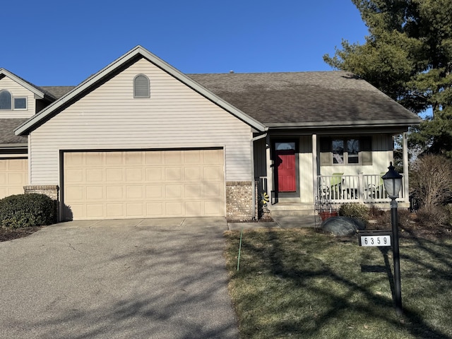 view of front of home with a porch, an attached garage, brick siding, a shingled roof, and concrete driveway