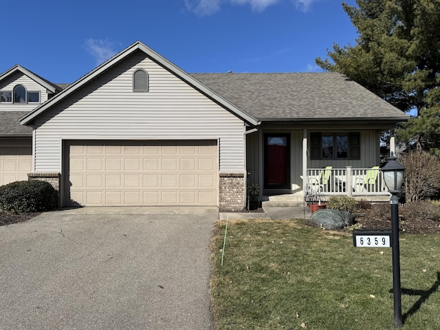 ranch-style house with a porch, a garage, brick siding, driveway, and roof with shingles