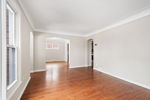 spare room featuring crown molding and hardwood / wood-style floors