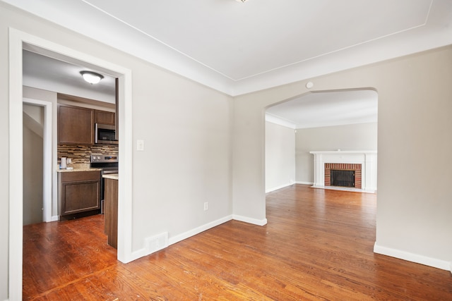 unfurnished living room featuring dark hardwood / wood-style floors and a fireplace