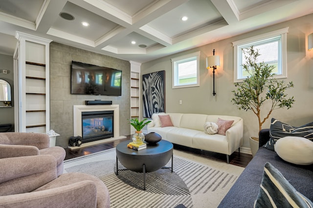 living room with coffered ceiling, wood-type flooring, a large fireplace, and beamed ceiling