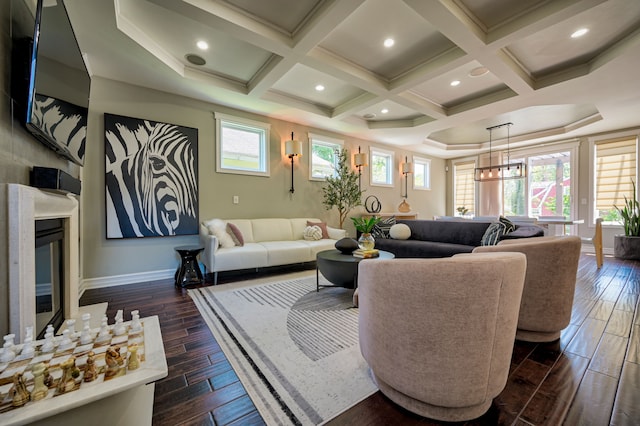 living room with dark wood-type flooring, coffered ceiling, and a premium fireplace