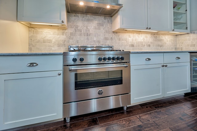 kitchen featuring white cabinetry, backsplash, dark hardwood / wood-style floors, ventilation hood, and high end stove