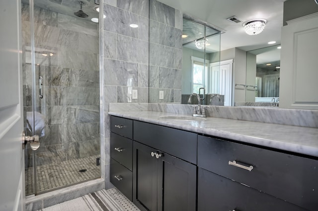 bathroom featuring vanity, tile patterned flooring, and walk in shower