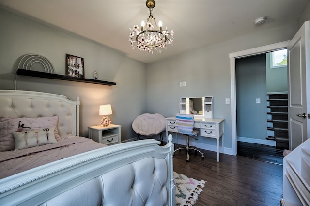 bedroom with dark hardwood / wood-style flooring and a chandelier