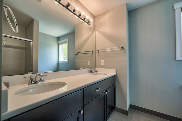 bathroom featuring walk in shower and vanity