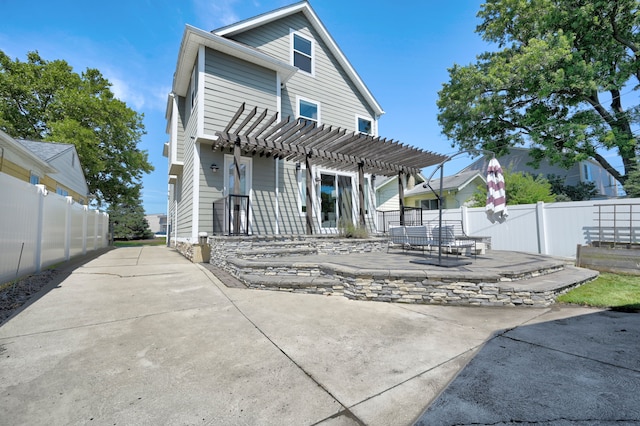 rear view of house with a patio and a pergola