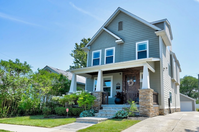 craftsman-style house featuring an outbuilding, a garage, and covered porch