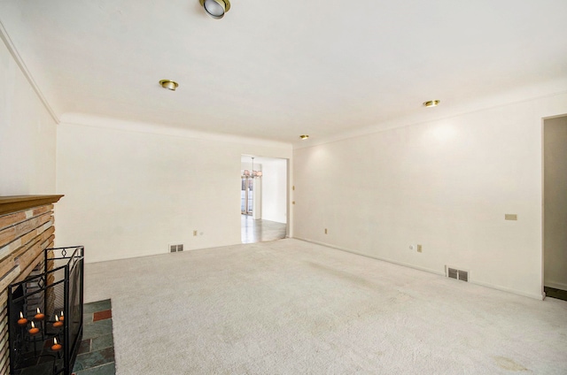 unfurnished living room with visible vents, carpet floors, and a fireplace