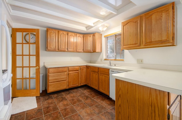 kitchen with a sink, beamed ceiling, white appliances, and light countertops