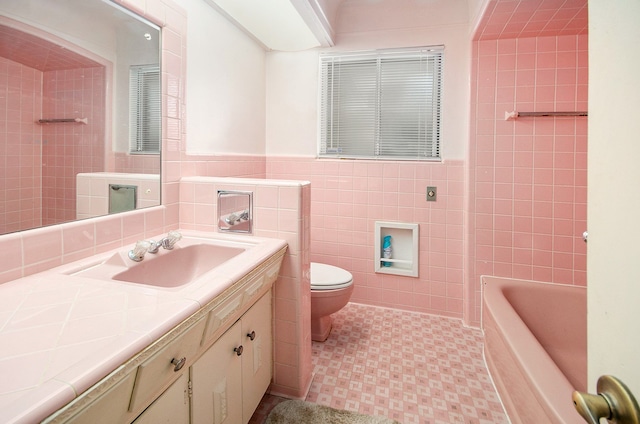 bathroom featuring a washtub, toilet, vanity, tile walls, and a shower