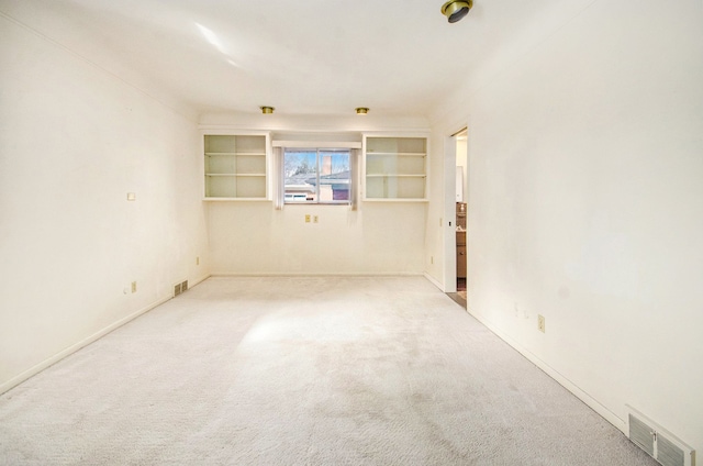 carpeted spare room with visible vents