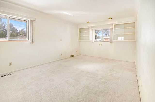 carpeted spare room with visible vents