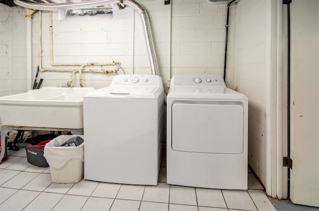 washroom featuring laundry area, a sink, and separate washer and dryer