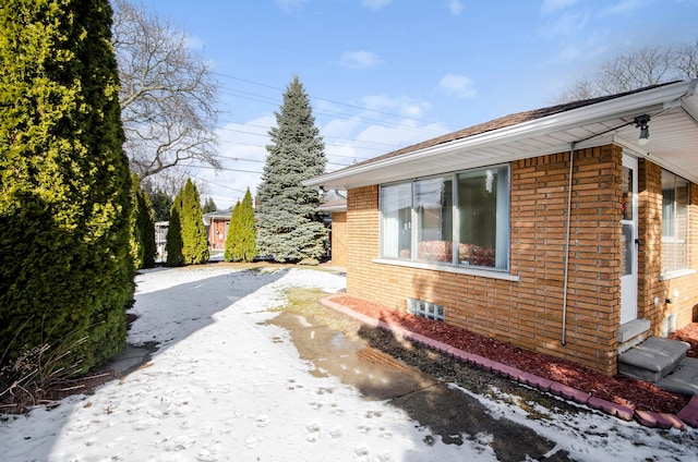 view of home's exterior with brick siding