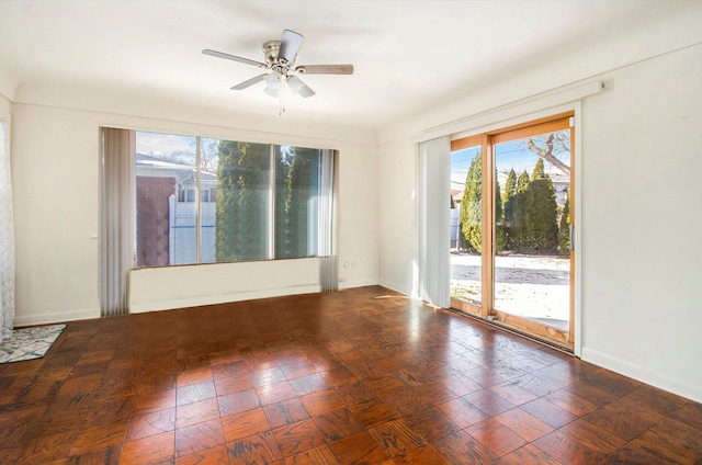 spare room featuring baseboards and ceiling fan