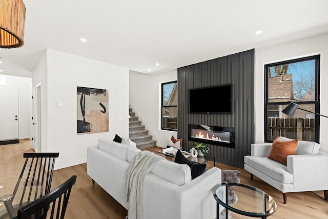 living room featuring a fireplace and light hardwood / wood-style floors