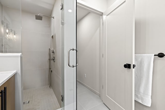 bathroom featuring vanity, tile patterned floors, and walk in shower