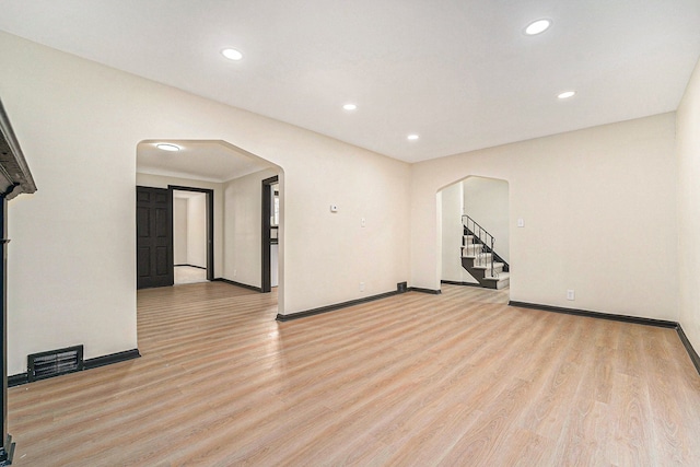 empty room with light hardwood / wood-style flooring