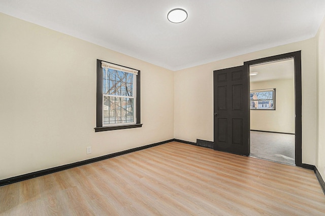 spare room with light hardwood / wood-style floors