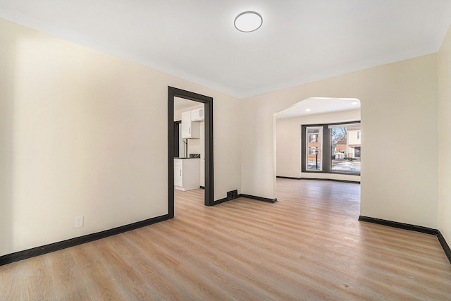 spare room featuring light hardwood / wood-style flooring