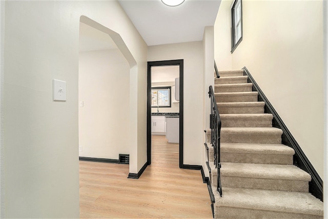 staircase featuring wood-type flooring