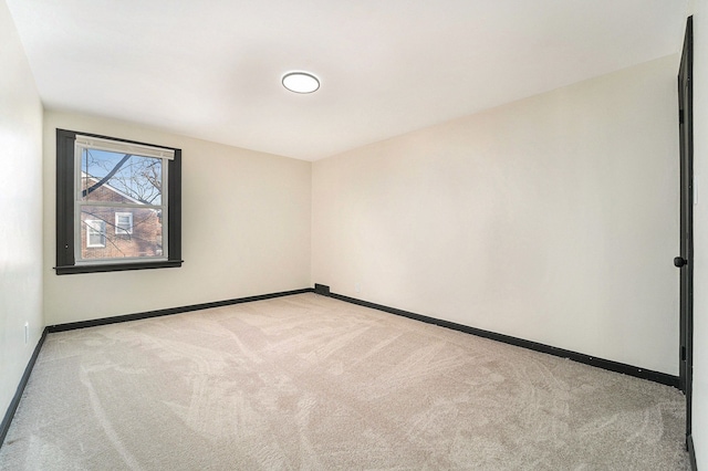 spare room with light colored carpet