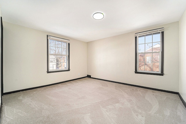 carpeted spare room with a healthy amount of sunlight