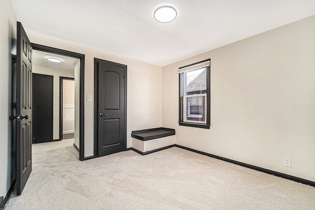 unfurnished bedroom featuring light carpet