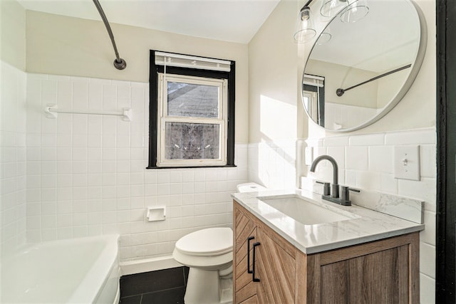 full bathroom with tile patterned flooring, tile walls, vanity, shower / bathing tub combination, and toilet