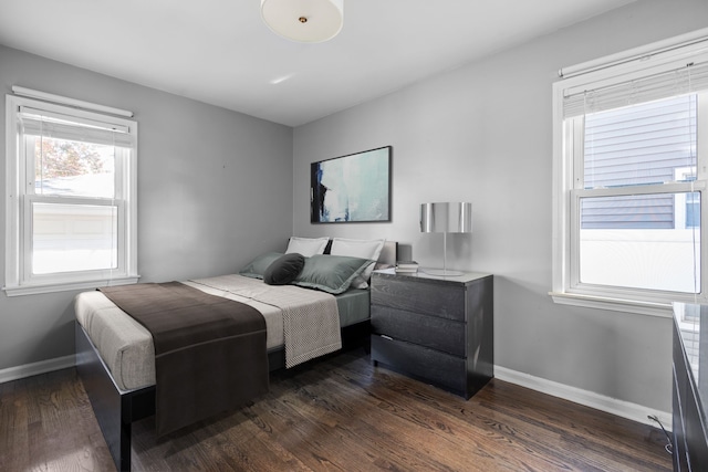 bedroom with dark wood-type flooring