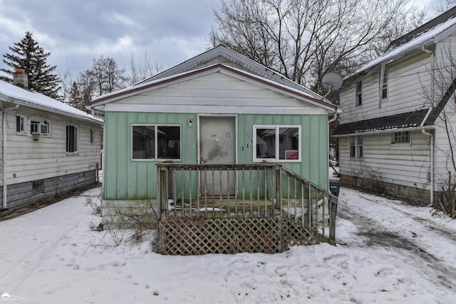 bungalow-style house with cooling unit