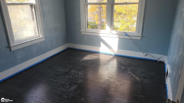 spare room with dark hardwood / wood-style flooring