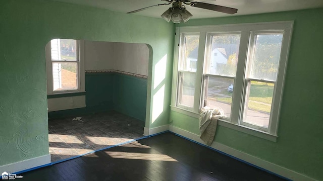 unfurnished room with a healthy amount of sunlight and ceiling fan